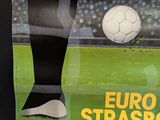 a poster of a soccer player kicking a soccer ball