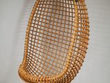 an image of a wicker hanging chair on a white wall