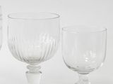 three wine glasses sitting next to each other on a table