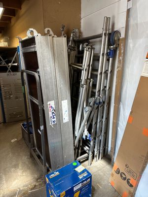 a pile of metal items in a garage with a box on the floor