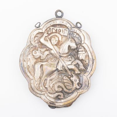 a silver medal with a picture of a woman riding a horse