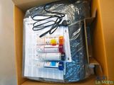 a cardboard box with a bunch of ink bottles in it