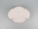 a white plate with a gold rim sitting on a table