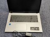 a laptop that is sitting on the floor with a charger