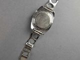 an image of a wrist watch on a table with a white background