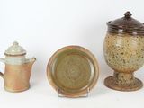three different types of pottery sitting on a white surface