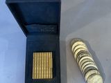 a small box of coins and a small coin on a table