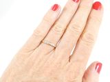a woman ' s hand with a diamond ring on it
