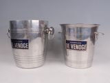 two silver metal buckets with handles and handles on a white surface
