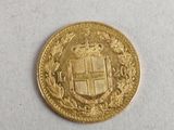 a close up of a gold coin with a coat of arms on it