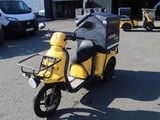 a small yellow motorcycle parked in a parking lot