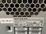 the back of a netgear power supply unit with wires attached to it