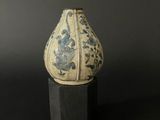 a vase that is sitting on top of a wooden stand