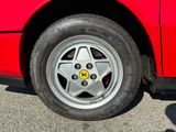 a close up of a red car with a star on the wheel