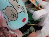 a stuffed animal sitting on top of a pile of toys
