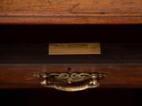 a close up of a drawer with a clock on top of it
