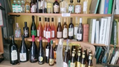 many bottles of wine sitting on a shelf in a room