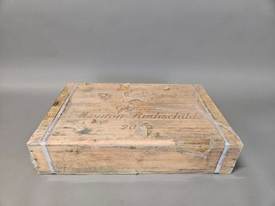 an old wooden box sitting on top of a gray surface