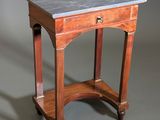a small table with a marble top on wheels