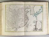 an open book with a map of china on top of it