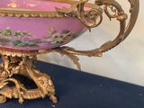 a purple and gold bowl sitting on a blue table