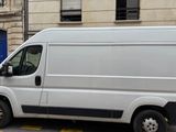 a white van that is parked in front of a building