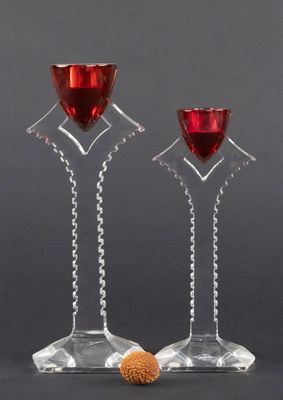 a pair of wine glasses with red wine in them on a black background