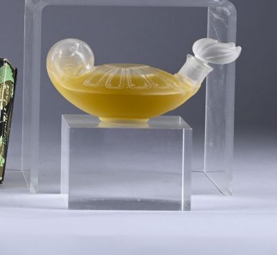 a glass bowl with a yellow liquid inside of it