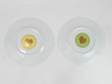 two glass plates with different designs on them on a white surface