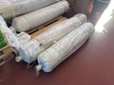 many rolls of paper sitting on top of a pallet