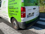 a green and white van parked on the side of the road