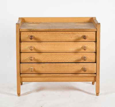 a small wooden dresser with three drawers on top of it