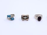 five different types of rings sitting on top of a white surface