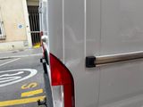 a white van that is parked on the side of the street