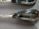 two spoons that are sitting next to each other on a table