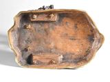 a small metal box with a handle on a white surface