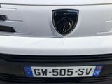 the front of a white car with a lamb logo on it ' s bumper