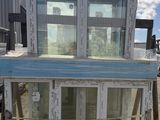 a blue and white building that has a glass door on top of it