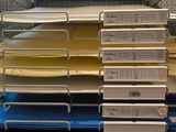 a stack of folders sitting on a shelf in a store