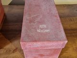 a small pink box sitting on a wooden table