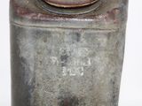 a metal container with a rusted lid on a white surface