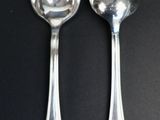 two spoons that are sitting on a table