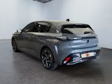 the rear end of a silver car in a showroom