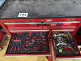 a red tool box with many tools inside of it