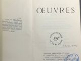 an open book with a stamp on it sitting on a table