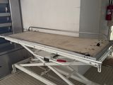 an image of a hospital room with a table in the middle of the room