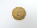an image of a gold coin on a white surface