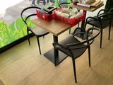 a table with chairs and a basket of food on top of it