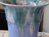 a blue bowl sitting on top of a white table