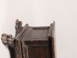 an old wooden cabinet with a cat on top of it